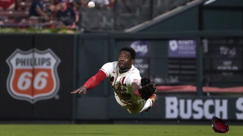 St. Louis Cardinals right fielder Jordan Walker dives and catches a fly ball by Washington Nationals' Riley Adams for an out during the eighth inning in the second game of a baseball doubleheader Saturday, July 15, 2023, in St. Louis. (AP Photo/Jeff Roberson)