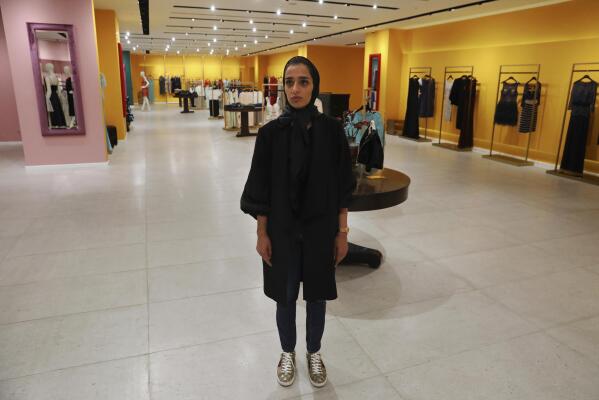 Nasrin Hassani, a 34-year-old dressmaker, poses for a photo in a women's clothing store at Tehran Mall shopping center, in Tehran, Iran, Wednesday, June 9, 2021. Iranians this week are preparing to vote in — or perhaps boycott — a presidential election that many fear will only underscore their powerlessness to shape the country's fate. “We have reached a point now that we wish we could return to where we were five and six years ago ... even if we can’t have things improved,” lamented Hassani. (AP Photo/Vahid Salemi)