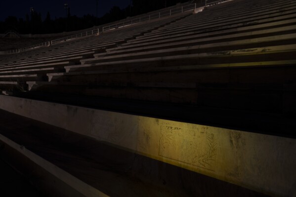 A seat with the name of Pierre de Coubertin is seen in the marble Panathinean Stadium, venue of the first modern Olympics in 1896, in Athens, early Friday, April 5, 2024. The seat Coubertin used at the renovated ancient marble stadium in the Greek capital is still preserved, with his name carved on it.(AP Photo/Petros Giannakouris)