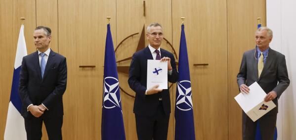 Finland's Ambassador to NATO Klaus Korhonen, NATO Secretary-General Jens Stoltenberg and Sweden's Ambassador to NATO Axel Wernhoff attend a ceremony to mark Sweden's and Finland's application for membership in Brussels, Belgium, Wednesday May 18, 2022. NATO Secretary-General Jens Stoltenberg said that the military alliance stands ready to seize a historic moment and move quickly on allowing Finland and Sweden to join its ranks, after the two countries submitted their membership requests. (Johanna Geron/Pool via AP)