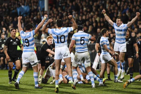 Argentina's players celebrate their Rugby Championship test match victory of New Zealand in Christchurch, New Zealand, Saturday, Aug. 27, 2022. (John Davidson/Photosport via AP)