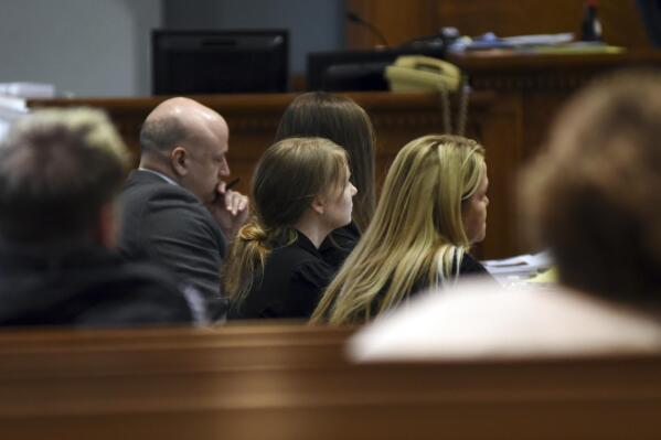 Timothy Hesemann, left, and Lynlee Renick, center, sit for the first day of trial at the Boone County Courthouse in Columbia, Mo., Monday, Dec. 6, 2021. Renick and ex-boyfriend Michael Humphrey are charged with carrying out the murder of Benjamin Renick. (Ciara McCaskill/Missourian via AP, Pool)
