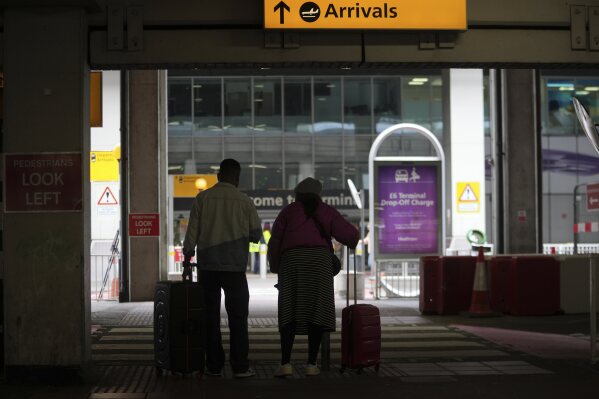 Traveller arrive with their lugage at Terminal 4 as Britain's Heathrow Airport has closed for the full day Friday after an electrical substation fire knocked out its power, disrupting flights for hundreds of thousands of passengers at one of Europe's biggest travel hubs in London, Friday, March 21, 2025.(AP Photo/Kin Cheung)
