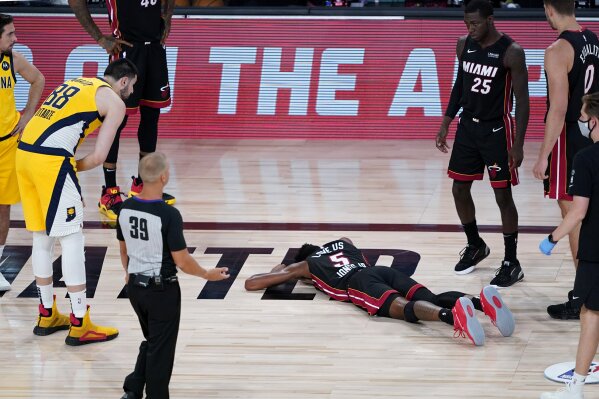 Miami Heat's Derrick Jones Jr. (5) lies on the court after being injured against the Indiana Pace...