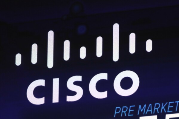 FILE - The Cisco logo appears on a screen at the Nasdaq MarketSite on Oct. 3, 2018 in New York's Times Square. (AP Photo/Richard Drew, File)