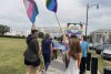 FILE - Connor McMahon, left, and Regan Collins walk in a rally outside the Alabama Statehouse in Montgomery, Ala. on International Transgender Day of Visibility, Friday, March 31, 2023. On Monday, Aug. 21, a federal appeals court ruled that Alabama can enforce a ban outlawing the use of puberty blockers and hormones to treat transgender children, the second such appellate victory for gender-affirming care restrictions that have been adopted by a growing number of Republican-led states. (AP Photo/Kim Chandler, File)