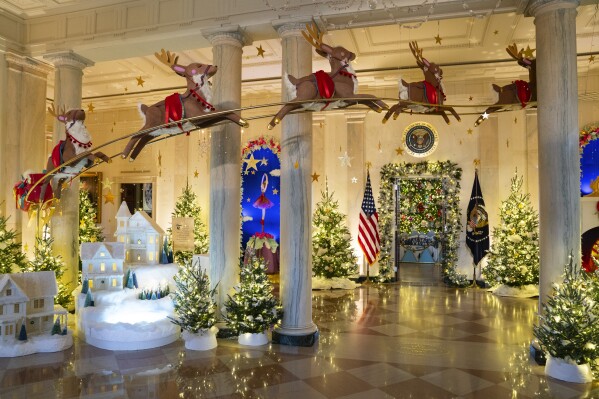 Holiday decorations adorn the Grand Foyer of the White House for the 2023 theme "Magic, Wonder, and Joy," Monday, Nov. 27, 2023, in Washington. (AP Photo/Evan Vucci)