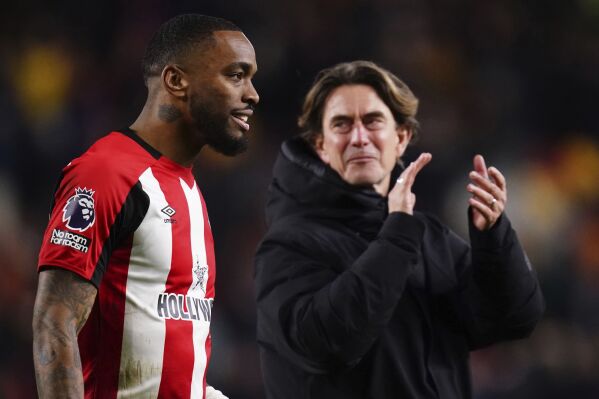 Brentford's Ivan Toney and manager Thomas Frank celebrate the win after the English Premier League soccer match between Brentford and Nottingham Forest, at the Gtech Community Stadium, in London, Saturday, Jan. 20, 2024. (John Walton/PA via AP)