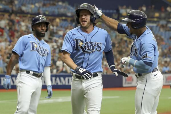 From left to right, Tampa Bay Rays' Randy Arozarena, Brett Phillips and Wander Franco celebrate after scoring on a double by Francisco Mejia during the sixth inning of a baseball game against the Chicago White Sox, Sunday, Aug. 22, 2021, in St. Petersburg, Fla. (AP Photo/Mike Carlson)