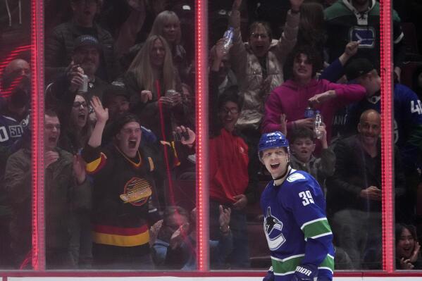 Vancouver Canucks' Alex Chiasson and fans celebrate his goal against the San Jose Sharks during the third period of an NHL hockey game Saturday, April 9, 2022, in Vancouver, British Columbia. (Darryl Dyck/The Canadian Press via AP)