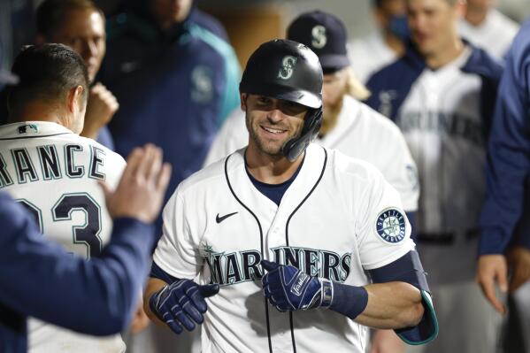 Seattle Mariners' Mitch Haniger celebrates in the dugout after hitting a solo home run in the seventh inning of a baseball game against the Oakland Athletics Tuesday, Sept. 28, 2021, in Seattle. (AP Photo/Jason Redmond)