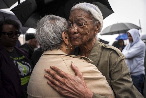 Amina Baraka, mother of Newark Mayor Ras J. Baraka, hugs Rep. Bonnie Watson Coleman, D-N.J., outside of an ICE office after her son's arrest, Friday, May 9, 2025, in Newark, N.J. (AP Photo/Angelina Katsanis)