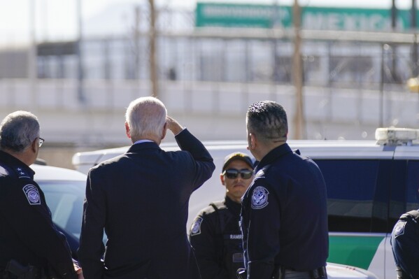 FILE - President Joe Biden, second from left, looks towards a large 