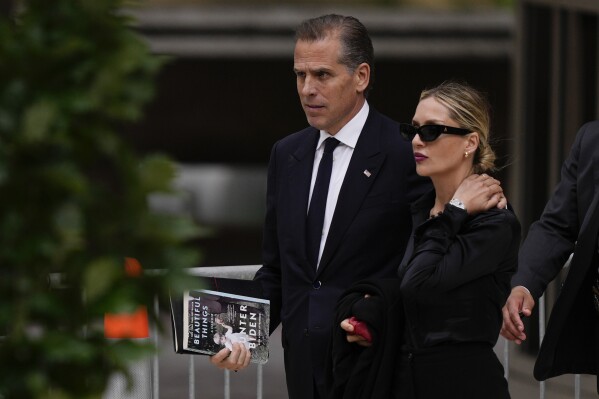 Hunter Biden, left, accompanied by his wife, Melissa Cohen Biden, depart from federal court, Wednesday, June 5, 2024, in Wilmington, Del. (AP Photo/Matt Rourke)