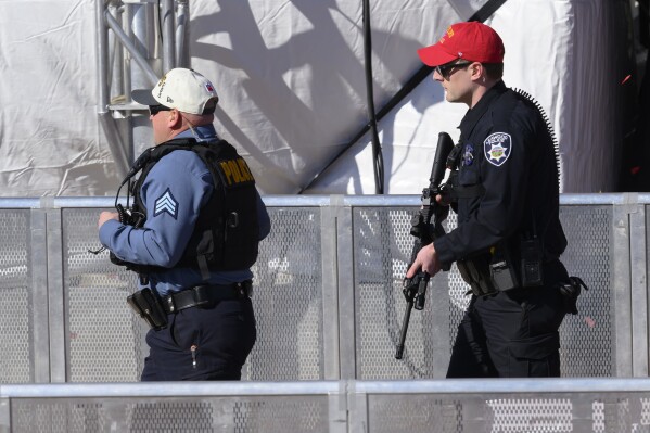 Law enforcement personnel arrive to investigate following a shooting at the Kansas City Chiefs NFL football Super Bowl celebration in Kansas City, Mo., Wednesday, Feb. 14, 2024. Multiple people were injured, a fire official said.(APPhoto/Reed Hoffmann)