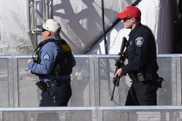 Law enforcement personnel arrive to investigate following a shooting at the Kansas City Chiefs NFL football Super Bowl celebration in Kansas City, Mo., Wednesday, Feb. 14, 2024. Multiple people were injured, a fire official said.(AP Photo/Reed Hoffmann)