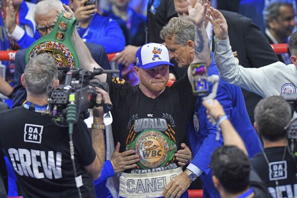 Canelo Alvarez, center, celebrates after wining against William Scull during super middleweight World Boxing Championship at ANB Arena in Riyadh, Saudi Arabia, Sunday, May 4, 2025. (AP Photo)