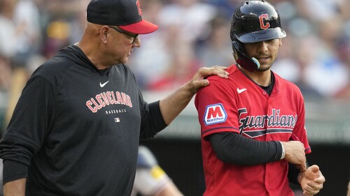 Cleveland Guardians manager Terry Francona, left, checks on Andres Gimenez after Gimenez was hit by an Atlanta Braves pitch during the third inning of a baseball game Wednesday, July 5, 2023, in Cleveland. (AP Photo/Sue Ogrocki)