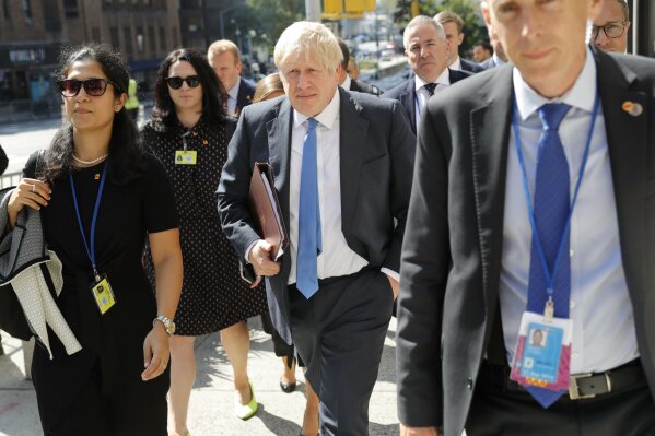 Britain's Prime Minister Boris Johnson walks down the street near United Nations headquarters in New York, Monday, Sept. 23, 2019. (AP Photo/Seth Wenig)