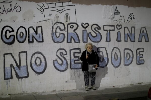 
              In this Oct. 6, 2018 photo, retiree Clara Schapiro, 75, poses for a picture backdropped by a wall emblazoned with a message that reads in Spanish: "With Cristina, you don't mess around," in reference to former President Cristina Fernandez, in Buenos Aires, Argentina. "She helps the people, helps everyone, so you're touched by a person like that," says Schapiro.  (AP Photo/Natacha Pisarenko)
            