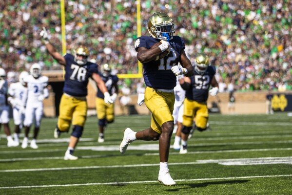 Notre Dame's Jeremiyah Love (12) runs for a touchdown during the first half of an NCAA college football game against Tennessee State on Saturday, Sept. 2, 2023, in South Bend, Ind. (AP Photo/Michael Caterina)