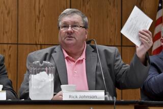 Rick Johnson chairs the committee as it meets before a capacity crowd in Lansing, Mich., Monday, June 26, 2017, at the first open meeting of the Michigan Medical Marijuana Board. Johnson, the former leader of the Michigan House had his phone seized as part of a federal investigation that involved grand jury subpoenas, search warrants and bank records, according to court documents.The details were disclosed in a 2021 lawsuit against Johnson and his wife, Janice, over fees charged by the Grand Rapids law firm Secrest Wardle. (Dale G Young/Detroit News via AP)