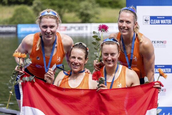 FILE - From left, Netherland's Marloes Oldenburg, Hermine Drenth, Tinka Offereins and Benthe Boonstra celebrate taking second place in the Women's Four Final A, at the 2024 World Rowing Cup at Rotsee, Sunday, May 26, 2024, in Lucerne, Switzerland. Two years after a nasty bicycle crash broke her back in multiple places, Oldenburg will be rowing again at the Paris Olympics. (Philipp Schmidli/Keystone via ĢӰԺ, File)