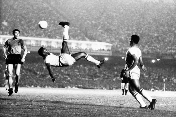 FILE - Brazil's soccer star Pele bicycle kicks a ball during a game at unknown location, Sept. 1968. Pelé, the Brazilian king of soccer who won a record three World Cups and became one of the most commanding sports figures of the last century, died in Sao Paulo on Thursday, Dec. 29, 2022. He was 82. (AP Photo File)