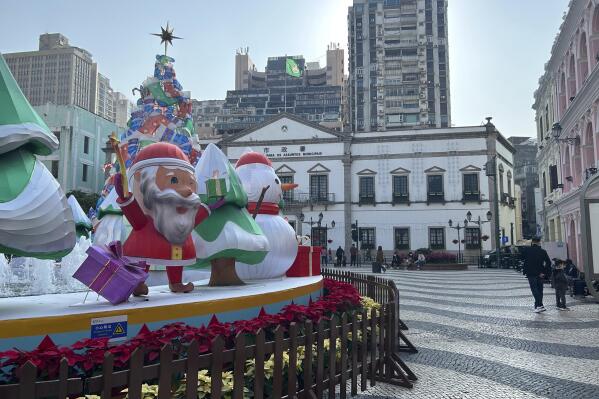 Tourist spot Senado Square remains quiet even after the easing of COVID entry restrictions in Macao on Dec. 28, 2022. Only a few tourists crisscrossed the wavy black and white paving of Macao's historic Senado Square on a recent weekday and many of the shops were shuttered. (AP Photo/Kanis Leung)