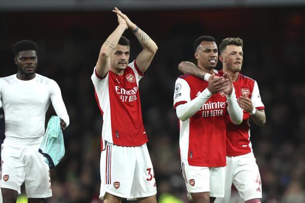 Arsenal players celebrate at the end of the English Premier League soccer match between Arsenal and Leicester City at the Emirates Stadium, in London, Sunday, March 13, 2022. (AP Photo/Ian Walton)