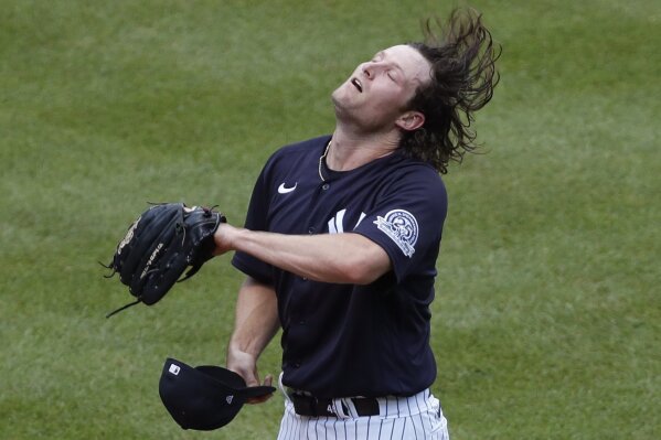 New York Yankees starting pitcher Gerrit Cole flips his hair before donning his cap between batters during an intrasquad game in baseball summer training camp Sunday, July 12, 2020, at Yankee Stadium in New York. (AP Photo/Kathy Willens)