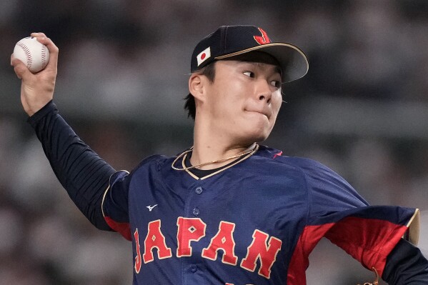 FILE - Yoshinobu Yamamoto, of Japan, pitches to Australia in the first inning of a Pool B game at the World Baseball Classic at Tokyo Dome in Tokyo, Sunday, March 12, 2023. Yamamoto will become a free agent Tuesday and major league teams can sign him through 5 p.m. EST on Jan. 4. Nippon Professional Baseball notified Major League Baseball that the 25-year-old right-hander’s club, the Orix Buffaloes, was posting him for availability to MLB teams. MLB notified the 30 teams of the posting on Monday, Nov. 20, 2023.(AP Photo/Eugene Hoshiko, File)