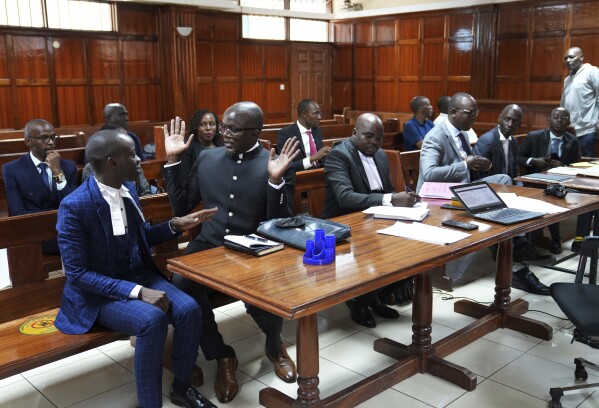 Lawyers react as Justice Chacha Mwita delivers judgement on a petition against the deployment of Kenyan forces to Haiti, at Milimani court in the capital Nairobi, Kenya, Friday, Jan. 26, 2024. A Kenyan court on Friday blocked the deployment of 1,000 police officers to Haiti, to help the Caribbean nation deal with gang violence. A declaration is issued that the National Security Council has no mandate to deploy the National Police Service, Justice Chacha ruled. (AP Photo/Brian Inganga)