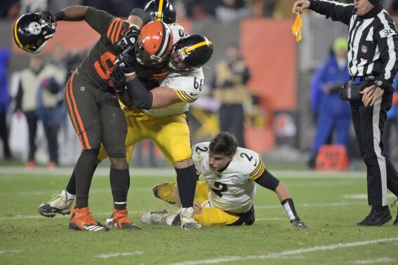 Cleveland Browns defensive end Myles Garrett, left, is grabbed by Pittsburgh Steelers offensive guard David DeCastro (66) after Garrett pulled the helmet off Pittsburgh Steelers quarterback Mason Rudolph (2) in the fourth quarter of an NFL football game, Thursday, Nov. 14, 2019, in Cleveland. The Browns won 21-7. (AP Photo/David Richard)