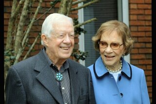 In this image from video, former President Jimmy Carter and former first lady Rosalynn Carter, seen in a photo as they speak on audio only, during the second night of the Democratic National Convention on Tuesday, Aug. 18, 2020. (Democratic National Convention via AP)