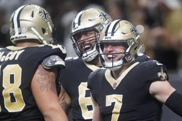New Orleans Saints' Taysom Hill, right, celebrates his 60 yard rushing touchdown with Erik McCoy, left, and J.P. Holtz during an NFL football game against the Seattle Seahawks in New Orleans, Sunday, Oct. 9, 2022. (AP Photo/Gerald Herbert)