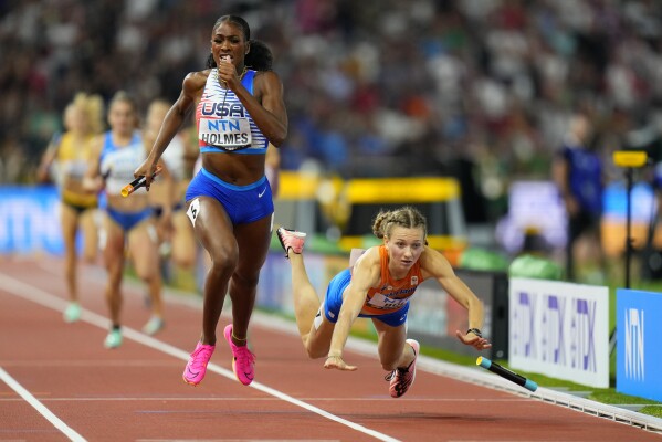 Alexis Holmes, of the United States anchors her team to the gold medal as Femke Bol, of the Netherlands fell near the finish in the final of the 4x400-meters mixed relay during the World Athletics Championships in Budapest, Hungary, Saturday, Aug. 19, 2023. (AP Photo/Petr David Josek)