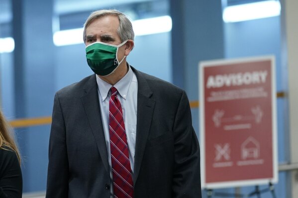 Sen. Jeff Merkley, D-Ore., walks on Capitol Hill in Washington, Thursday, Feb. 11, 2021, before the start of the third day of the second impeachment trial of former President Donald Trump. (AP Photo/Susan Walsh)