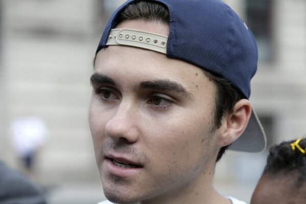 
              FILE - In this Aug. 23, 2018, file photo, David Hogg, a survivor of the school shooting at Marjory Stoneman Douglas High School, in Parkland, Fla., speaks with reporters before a march in Worcester, Mass. Hogg's remarks during a CNN interview is among those on a Yale Law School librarian's list of the most notable quotes of 2018: "We're children. You guys, like, are the adults. You need to take some action and play a role. Work together, come over your politics and get something done." (AP Photo/Steven Senne, File)
            