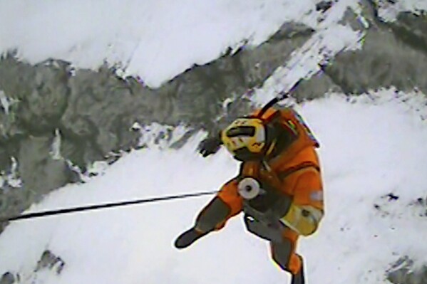 In this image taken from video provided by the U.S. Coast Guard, U.S. Coast Guard Air Station Detroit and Station Marblehead respond to a report of ice fishermen stranded on an ice floe near Catawba Island on Lake Erie, Ohio, Monday, Jan. 22, 2024. Twenty people were rescued from an ice floe in Lake Erie, the Coast Guard said Monday. (U.S. Coast Guard via AP)