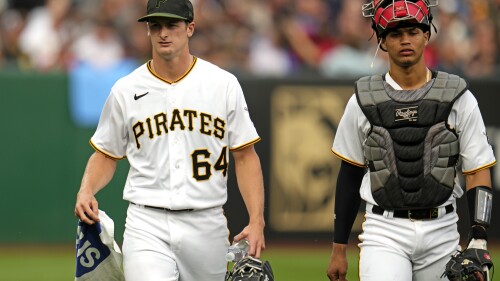 Pittsburgh Pirates starting pitcher Quinn Priester (64) walks from the bullpen after warming up with catcher Endy Rodriguez for their major league debuts in a baseball game against the Cleveland Guardians in Pittsburgh, Monday, July 17, 2023. (AP Photo/Gene J. Puskar)