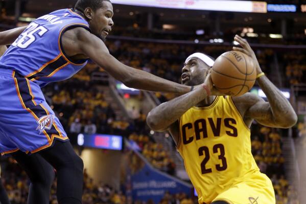 Oklahoma City Thunder's Kevin Durant fouls Cleveland Cavaliers' LeBron James (23) in the fourth quarter of an NBA basketball game Sunday, Jan. 25, 2015, in Cleveland. The Cavaliers won 108-98 to run their winning streak to six games. (AP Photo/Mark Duncan)