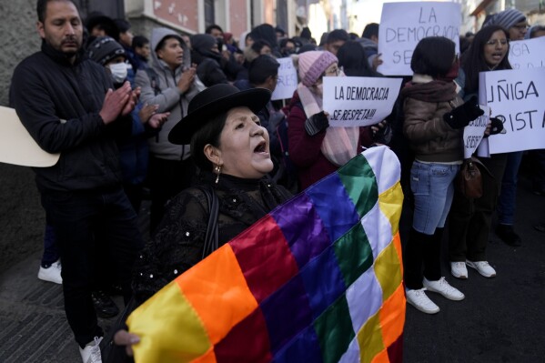 Alicia Chura, a supporter of Bolivian President Luis Arce, shouts against a now-ousted Bolivian army chief who led some soldiers to storm the presidential palace, outside police offices in La Paz, Bolivia, Thursday, June 27, 2024. The rebellion was short-lived as authorities arrested Gen. Juan Jose Zuniga and his soldiers retreated. (AP Photo/Juan Karita)