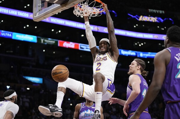 FILE - Los Angeles Lakers forward Jarred Vanderbilt dunks as Utah Jazz forward Kelly Olynyk defends during the first half of an NBA basketball game Sunday, April 9, 2023, in Los Angeles. The Los Angeles Lakers have agreed to a four-year, $48 million contract extension with forward Jarred Vanderbilt, a person with knowledge of the deal told The Associated Press on Friday, Sept. 15.(AP Photo/Mark J. Terrill, File)