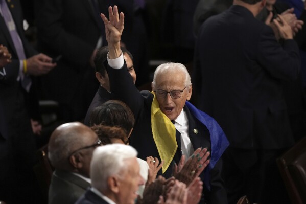 Rep. Bill Pascrell, D-N.J., holds up four fingers for 'four more years' as President Joe Biden delivers the State of the Union address to a joint session of Congress at the U.S. Capitol, Thursday March 7, 2024, in Washington. (AP Photo/Andrew Harnik)
