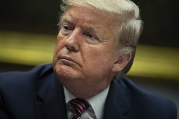 President Donald Trump listens during a small business roundtable in the Roosevelt Room of the White House, Friday, Dec. 6, 2019, in Washington. (AP Photo/ Evan Vucci)