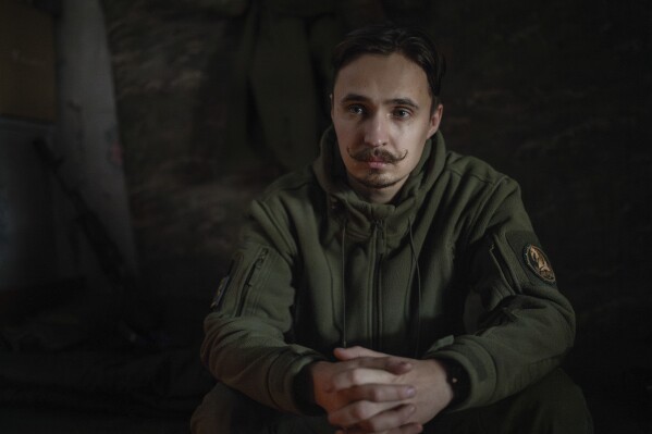The serviceman of 47th brigade known by call-sign "Azimuth", 33, pauses, during an interview with The Associated Press, in Donetsk region, Ukraine, Thursday, Feb. 29, 2024. The loss of the city of Avdiivka last month marked the end of a long, exhausting defense for the Ukrainian military. One brigade had defended the same block of buildings for months without a break. (AP Photo/Alex Babenko)