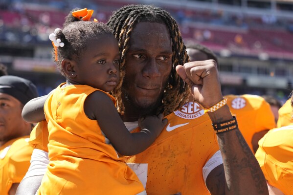 Tennessee quarterback Joe Milton III, right, celebrates the team's 49-13 win against Virginia with his one-year-old sister Journey after an NCAA college football game Saturday, Sept. 2, 2023, in Nashville, Tenn. (AP Photo/George Walker IV)