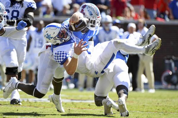 Mississippi safety AJ Finley (21) and linebacker Austin Keys (11) force a fumble from Kentucky quarterback Will Levis (7) during the second half of an NCAA college football game in Oxford, Miss., Saturday, Oct. 1, 2022. Mississippi won 22-19. (AP Photo/Thomas Graning)