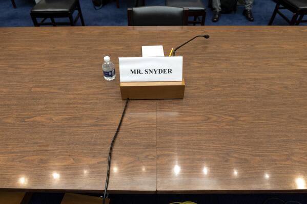 A placard for Dan Snyder, owner of the Washington Commanders football team, is seen, Wednesday, June 22, 2022, during a Hous​e Oversight Committee hearing on the Washington Commanders' workplace conduct, on Capitol Hill in Washington. Snyder did not attend the hearing virtually or otherwise. (AP Photo/Jacquelyn Martin)